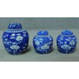 Three blue and white ginger jars with lids, with blossom decoration. H.17cm (tallest)