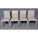 A set of four leather covered dining chairs. H.84cm