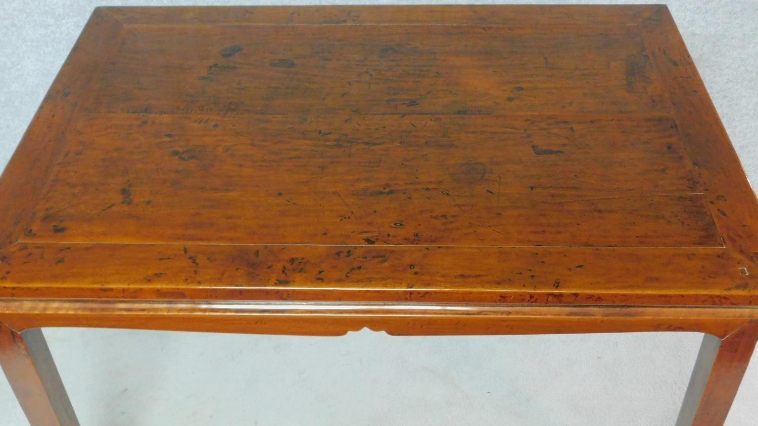 A Chinese teak centre table on shaped tapering square section supports. H.87 W.135 D.89cm - Image 3 of 5