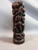 A carved African hardwood tree of life statue with carved tribal figures. H 32cm.