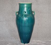 A large green drip glazed sharab wine vessel with four handles. H.87cm