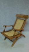 A Colonial style teak folding deck chair with caned back and seat. H.91cm