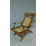 A Colonial style teak folding deck chair with caned back and seat. H.91cm