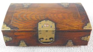 A Chinese wooden box with brass details with swing handle and Chinese script to the inside. 30x19x