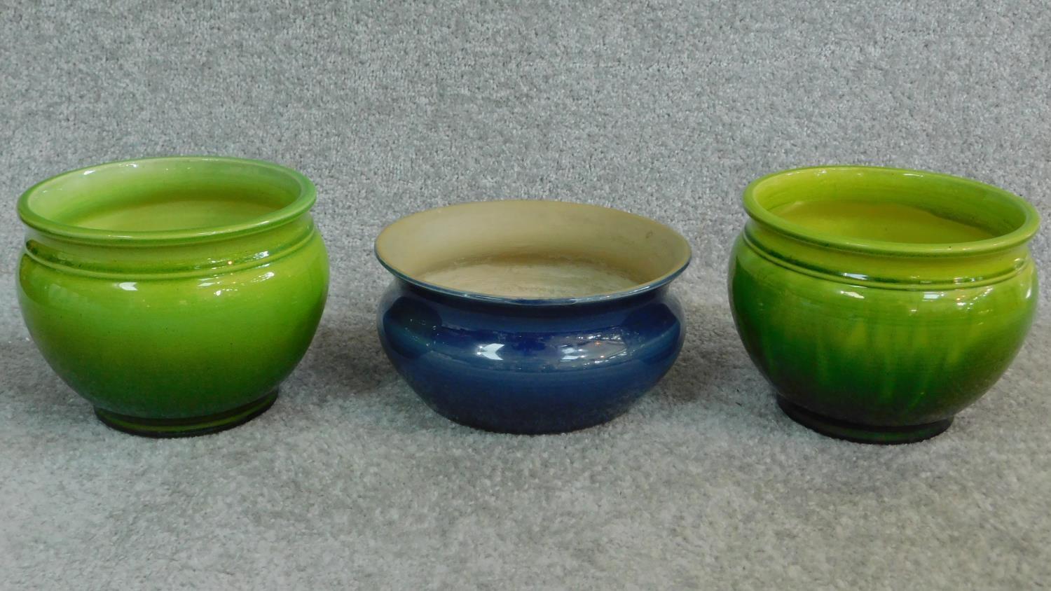 A pair of antique green Bretby pots with makers stamp to base and numbered '14220' with another blue