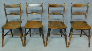 A set of four 19th century country bar back dining chairs with elm seats on turned stretchered