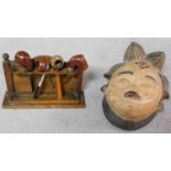 A tribal African Punu Female Okau figure mask and a collection of four Vintage wooden and plastic