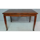 A Chinese teak centre table on shaped tapering square section supports. H.87 W.135 D.89cm