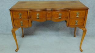 An early Georgian style burr walnut desk on shell carved cabriole supports. H.77 W.113 D.56cm