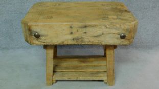 An antique elm butchers block on rustic pine base. H.71 W.99 D.60cm