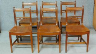 A set of six 19th century mahogany dining chairs with solid seats and squab cushions on square