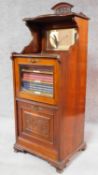 A late Victorian walnut music cabinet with fitted shelved interior containing various volumes of