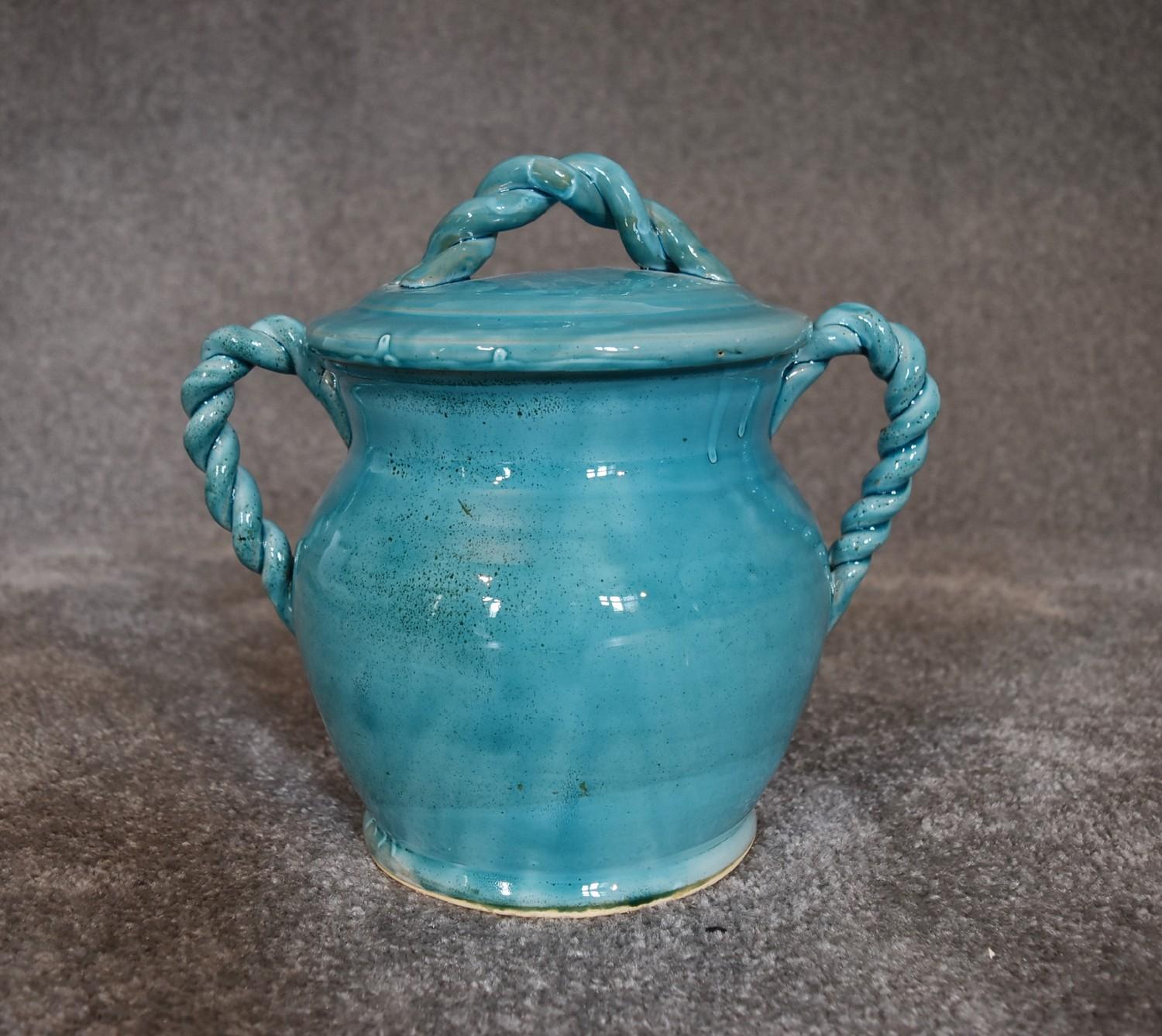 A Persian glazed ceramic blue pot with lid. H.20cm x W.18cm