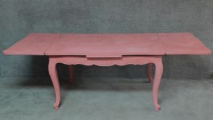 A painted French extending dining table on carved cabriole supports. H.75 W.237 D.99cm