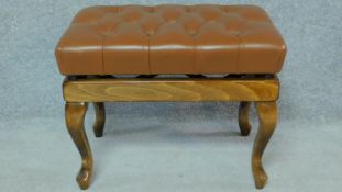 A buttoned leather adjustable piano stool on cabriole supports. H.45 W.65 D.41cm