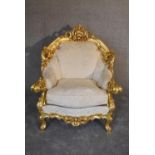 A heavily carved giltwood Baroque style armchair in floral damask. H.110 x 69cm