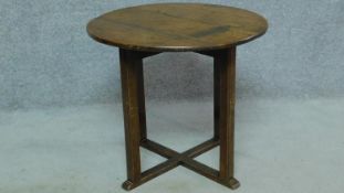 An antique country oak circular centre table on square stretchered supports. H.57 W.63cm