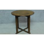 An antique country oak circular centre table on square stretchered supports. H.57 W.63cm