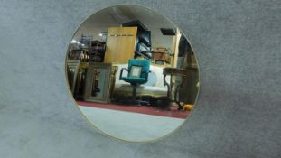 A large circular gilt framed wall mirror. D.91cm