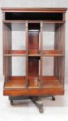 A large late 19th century mahogany revolving bookcase on brass casters. H.106 W.65 D.64cm