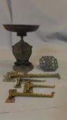 An antique brass weighing scale and other brass items and a collection of brass wall mounted