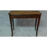 An early 19th century mahogany inlaid flap top tea table on tapering sabre supports. H.72 W.90 D.91