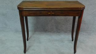 An early 19th century mahogany inlaid flap top tea table on tapering sabre supports. H.72 W.90 D.91