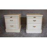 A pair of cream two drawer bedside cabinets fitted with two drawers and slides to frieze. 47cm x