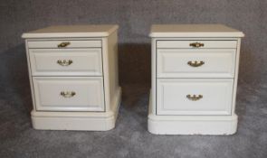 A pair of cream two drawer bedside cabinets fitted with two drawers and slides to frieze. 47cm x