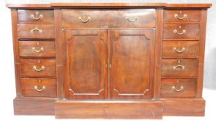 A late 19th century Georgian style breakfront sideboard with rosewood crossbanded top fitted central