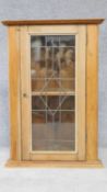 A pine wall hanging corner cabinet with leaded glass door. H.92 W.65 D.38cm