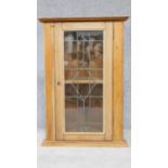 A pine wall hanging corner cabinet with leaded glass door. H.92 W.65 D.38cm