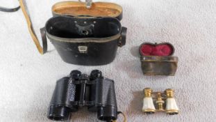 A pair of USSR military binoculars in leather case with night vision lenses with a pair of pearl and