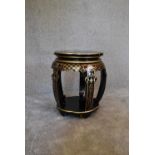 A black lacquered and gilt decorated Chinese stool. 50cm tall x 35cm diameter.