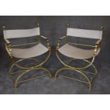 A pair of brass X framed Romanesque armchairs with cream leather upholstery. H.87 x 63cm