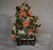A Chinese carved jade and agate ornamental blossom tree with carved petals and leaves, in