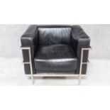 A black faux leather upholstered Le Corbusier style armchair with chrome tubular frame. H.74 W.94