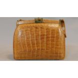 A vintage crocodile skin evening bag with brass swing, clip catch and tan suede interior with