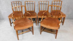 A set of six Georgian elm dining chairs with wheatsheaf carved splats on square tapering supports.