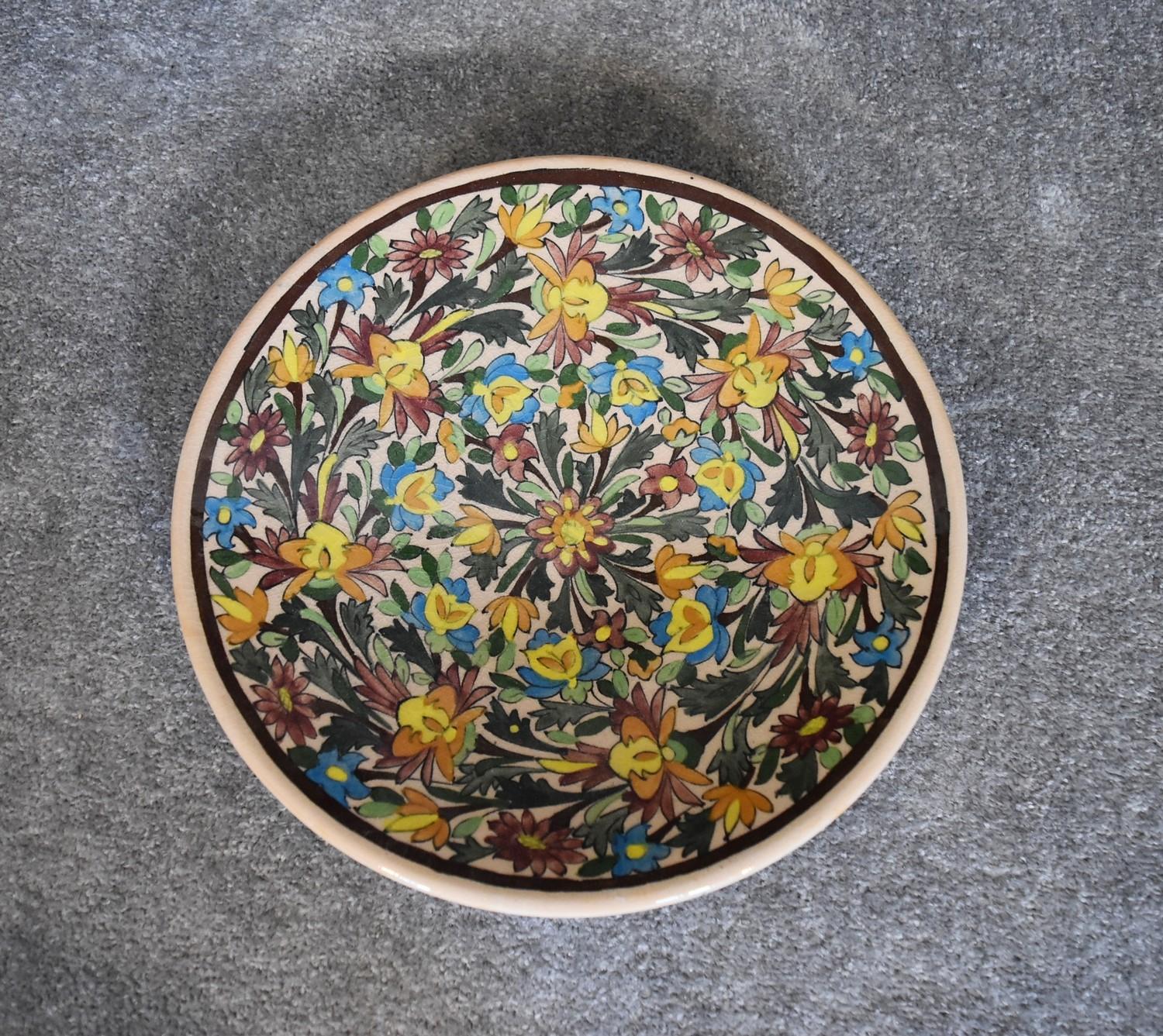 A large ceramic Persian shallow bowl with allover floral pattern. Dia.36cm