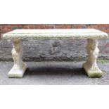 A large weathered concrete garden table in the Neo Classical style with rectangular top raised on