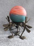 An Art Deco brass dragonfly lamp with orange and turquoise marbled blown frosted glass globe