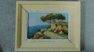 A framed oil on board depicting a hill by the ocean, indistinctly signed. 32x26cm
