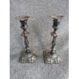 A pair of 1854 Elkington and Co silver plate candle sticks with repousse design. H 26
