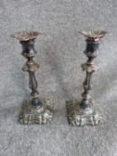 A pair of 1854 Elkington and Co silver plate candle sticks with repousse design. H 26