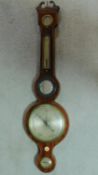 A Georgian mahogany and satinwood strung barometer. H.97cm (damage to mercury tube).