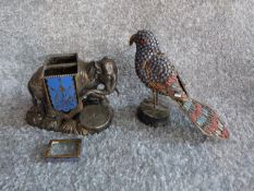 An antique silver plate and blue enamel elephant match holder with gilded details and an indian