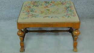 An early 20th century William and Mary walnut footstool with a tapestry drop in seat. H.41 W.66 D.