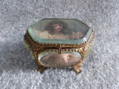 A 19th century French bronze casket trinket box having multiple beveled glass panels raised on