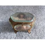 A 19th century French bronze casket trinket box having multiple beveled glass panels raised on